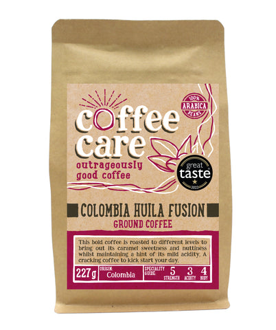 A 227g kraft packet of Coffee Care’s Colombia Huila Fusion ground coffee. Pink label ground for filter & cafetiere. 100% Arabica ground coffee beans. Great Taste Winner 2022.