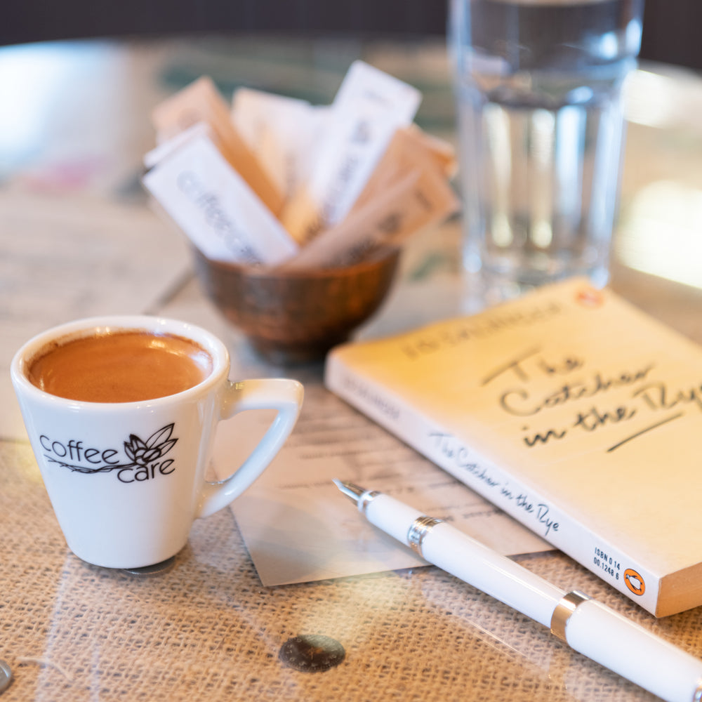 cup of coffee with pen and notebook