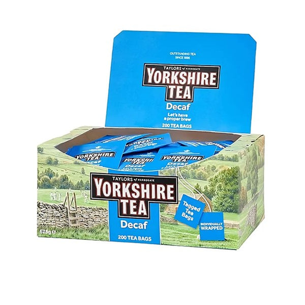 Side View of open box of Yorkshire Tea Decaf with a landscape image on cardboard box of 200 one cup individually foil wrapped tagged decaffeinated tea bags. Yorkshire Tea, Taylors of Harrogate - Let’s have a proper brew