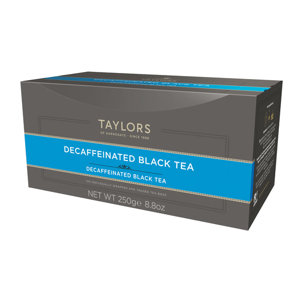 Side view of large grey cardboard box with 100 individually wrapped and tagged Taylors of Harrogate Decaffeinated Breakfast Tea. Blue label –Bright & refreshing black tea