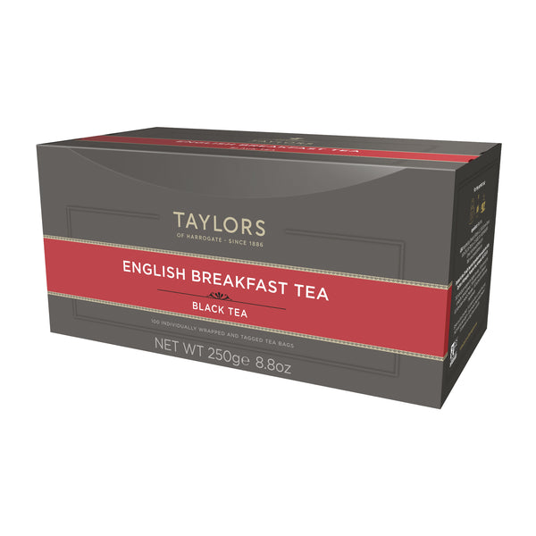 Side view of large grey cardboard box with 100 individually wrapped and tagged Taylors of Harrogate English Breakfast tea bags. Red label – Rich & bright black tea