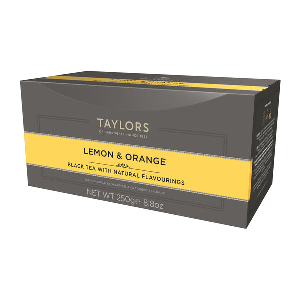 Side view of large grey cardboard box with 100 individually wrapped and tagged Taylors of Harrogate English Breakfast tea bags. Orange label – Black tea with natural flavourings