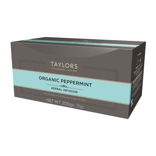 Side view of large grey cardboard box with 100 individually wrapped and tagged Taylors of Harrogate Organic Peppermint. Light blue label – Fresh & vibrant caffeine free infusion