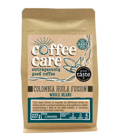A 227g kraft packet of Coffee Care’s Colombia Huila Fusion Coffee. Blue label for whole beans. Colombian coffee. 100% Arabica whole beans