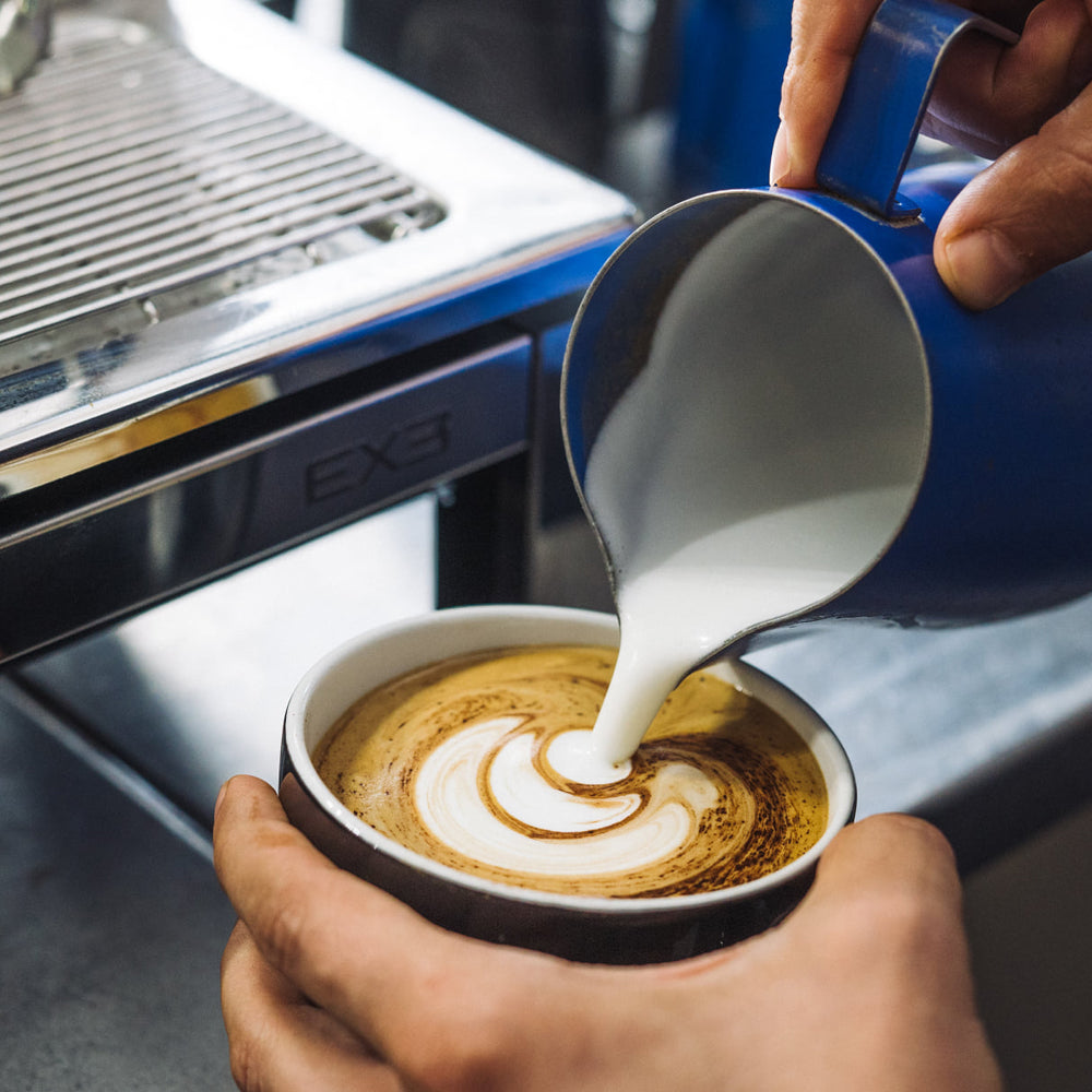 milk being added to coffee