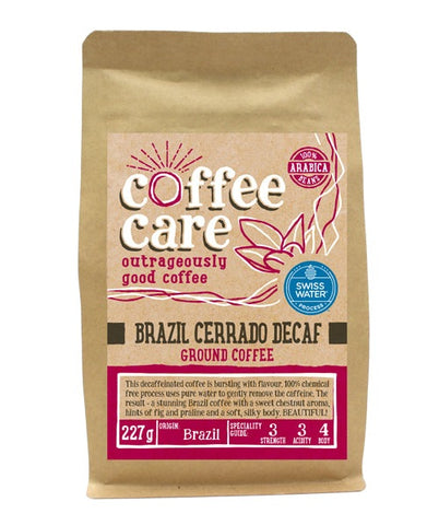 A 227g kraft packet of Coffee Care’s Brazil Cerrado Swiss Water Process Decaffeinated Coffee. Pink label ground for filter & cafetiere. 100% Arabica ground coffee beans