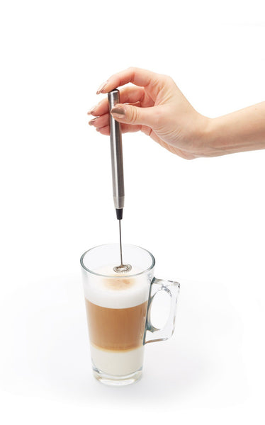 A Le'Xpress  slimline chrome frother whipping milk for a latte.