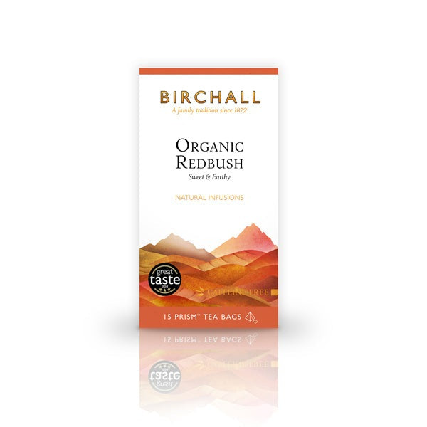 Front view of cardboard box of 15 Birchall Organic Redbush prism tea bags. Orange hill graphics with orange band, sweet & earthy, natural infusion. Caffeine free. Great Taste winner 2014